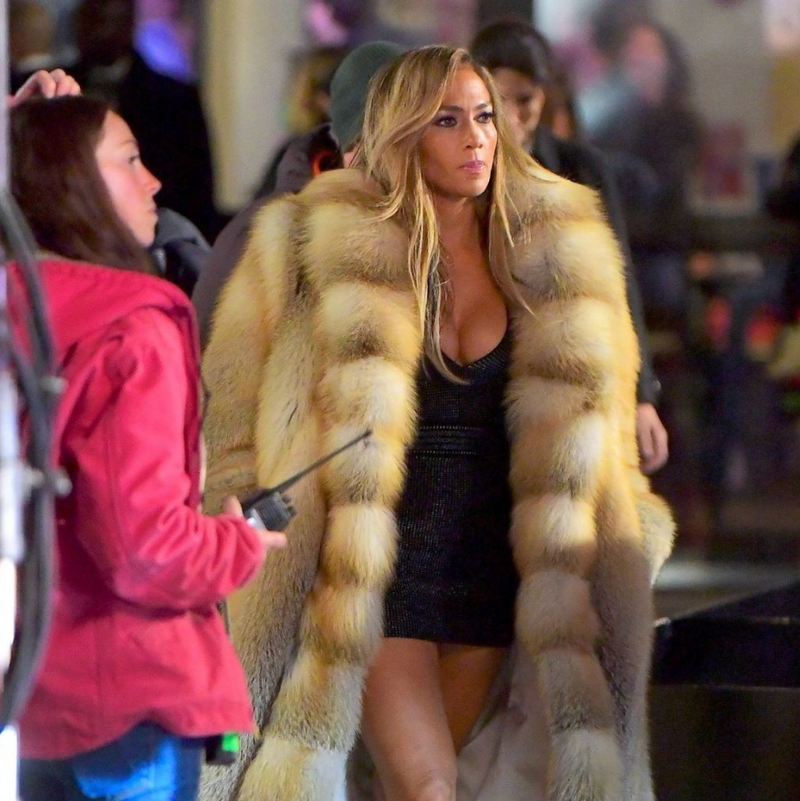 Jennifer Lopez wearing a long fox fur coat by Lilly e Violetta on a city street