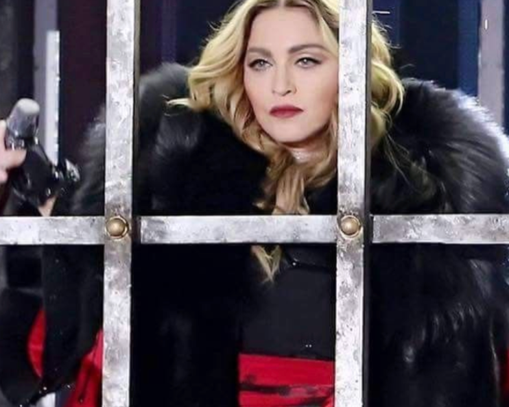 Madonna wearing a black fur coat  by Lilly e Violetta with red accents at the opening of the Rebel Heart Tour 