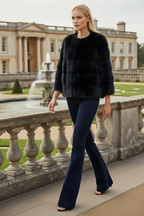 Navy Blue mink fur jacket by lilly e violetta worn by a blond model on a white background