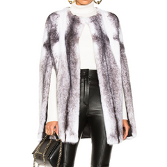 Person wearing a patterned coat, white turtleneck, black leather pants, and holding a black handbag on a white background